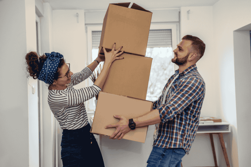 homem e mulher carregando caixas